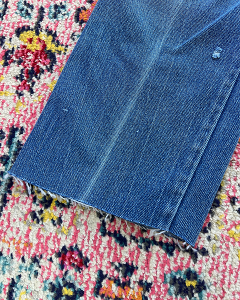 Blue denim fabric on a colorful patterned rug