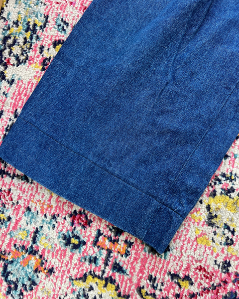 Blue fabric on a colorful floral-patterned surface