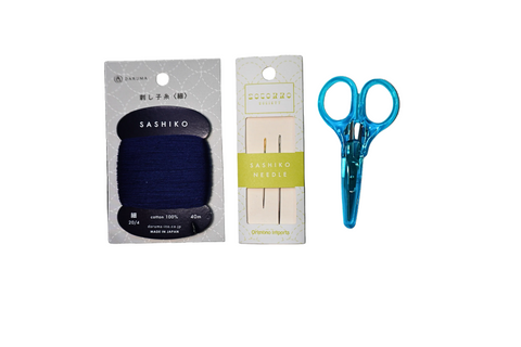 Sashiko tool set with blue scissors, black sashiko tool, and wooden needles on a white background