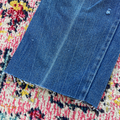 Blue denim fabric on a colorful patterned rug