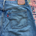 Close-up of blue Levi's jeans with brand logo on a colorful patterned background