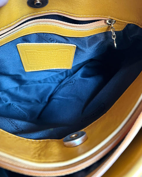 Close-up of a yellow and blue bag with a visible brand label.